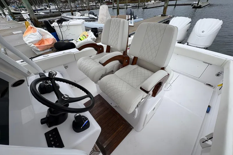 Changes In Lattitudes Yacht Photos Pics Luxury seating and steering area on 2023 Jupiter 30 boat at marina.