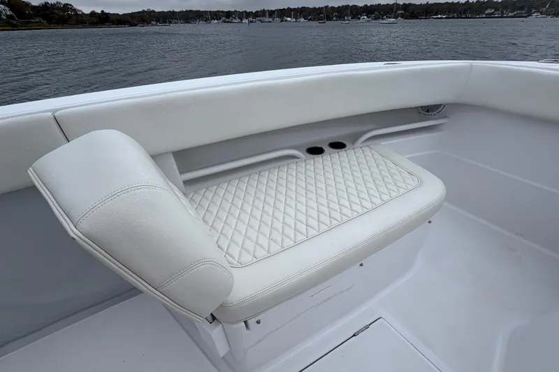 Changes In Lattitudes Yacht Photos Pics Luxurious white seating on 2023 Jupiter 30 boat, featuring diamond-pattern upholstery.