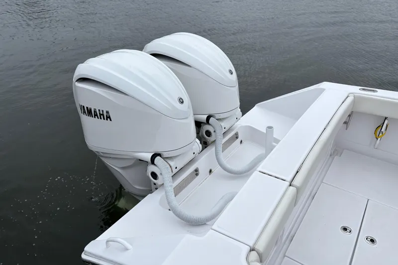 Changes In Lattitudes Yacht Photos Pics 2023 Jupiter 30 boat with dual Yamaha outboard motors on calm water.