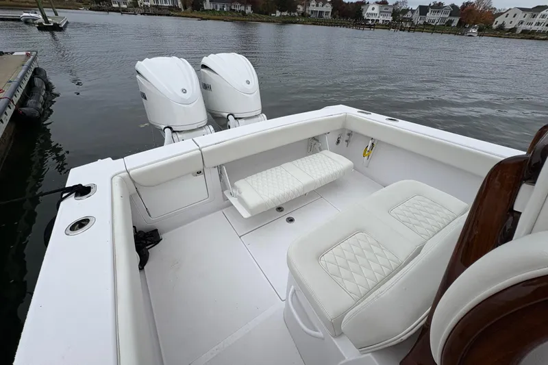 Changes In Lattitudes Yacht Photos Pics 2023 Jupiter 30 boat with dual engines, white seating, docked by waterfront homes.