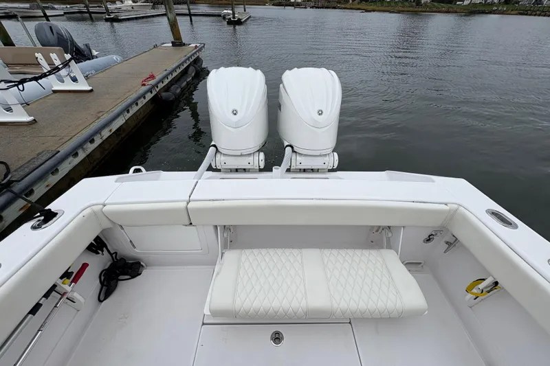 Changes In Lattitudes Yacht Photos Pics 2023 Jupiter 30 boat with dual engines, docked at marina, featuring white seating.