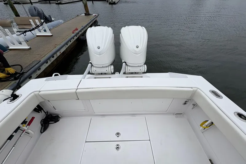 Changes In Lattitudes Yacht Photos Pics 2023 Jupiter 30 boat with dual outboard engines docked at marina.