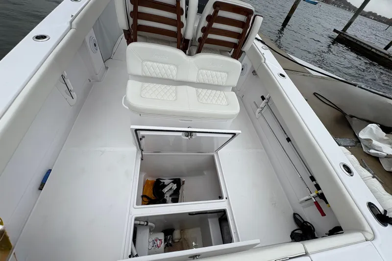 Changes In Lattitudes Yacht Photos Pics 2023 Jupiter 30 boat interior with white seating and open storage compartments.