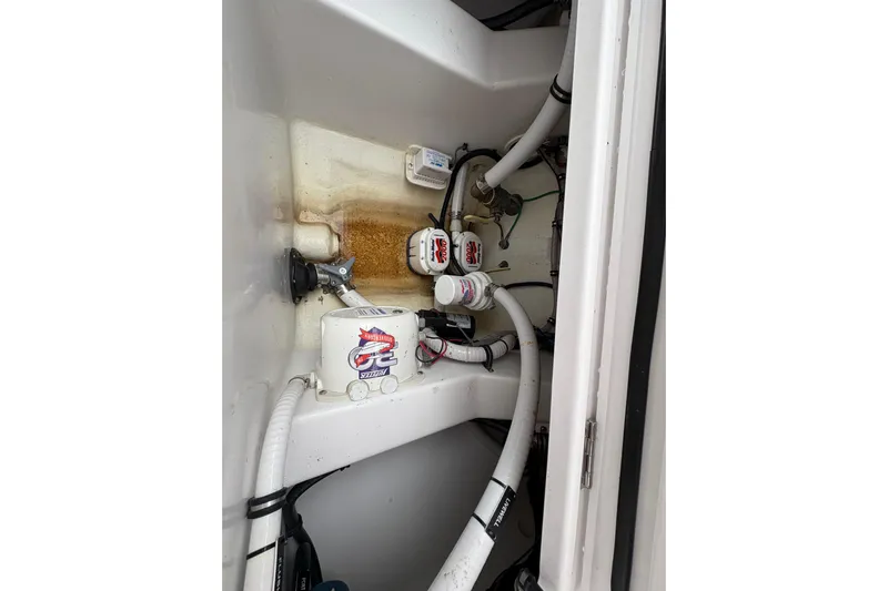 Changes In Lattitudes Yacht Photos Pics 2023 Jupiter 30 boat interior showing plumbing and wiring components.