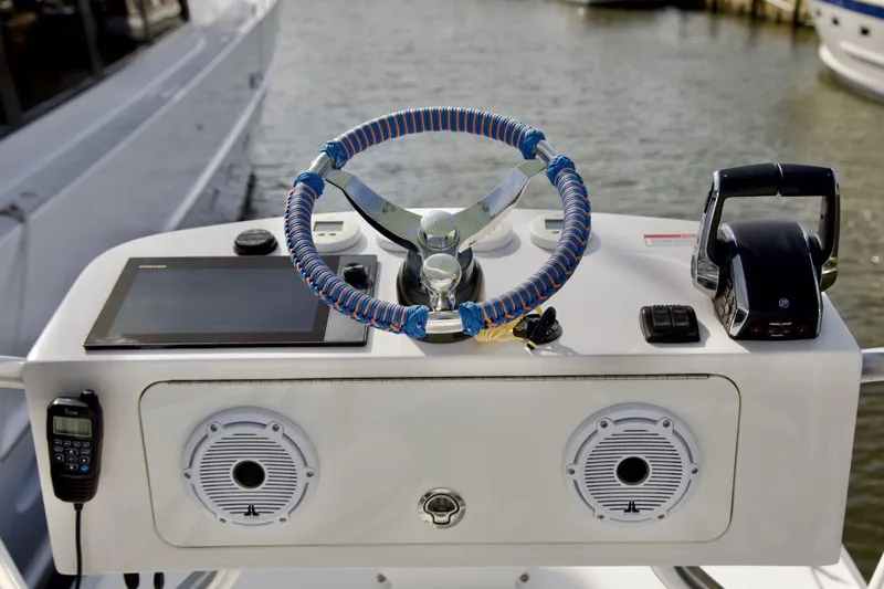  Yacht Photos Pics 2024 SeaVee 390Z boat helm with modern controls and blue-wrapped steering wheel.