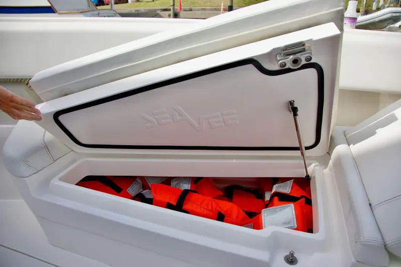  Yacht Photos Pics Open storage compartment on 2024 SeaVee 390Z boat, containing orange life jackets.