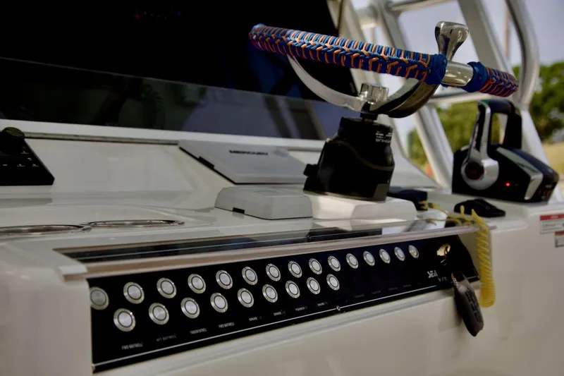  Yacht Photos Pics 2024 SeaVee 390Z boat dashboard with colorful steering wheel and control panel.