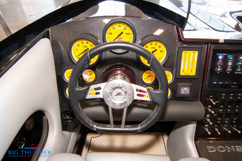  Yacht Photos Pics 2020 Donzi 38 ZRC boat dashboard with yellow gauges and steering wheel.