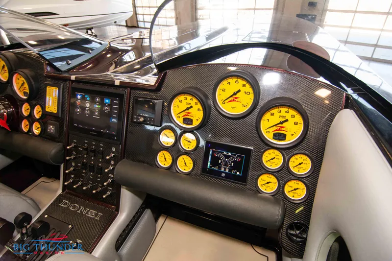 Yacht Photos Pics Dashboard of a 2020 Donzi 38 ZRC boat with yellow gauges and advanced controls.