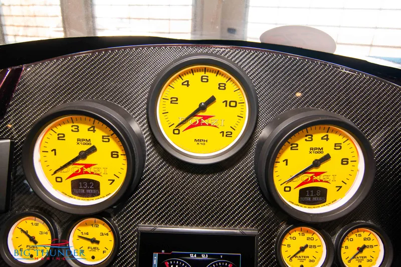  Yacht Photos Pics Dashboard of a 2020 Donzi 38 ZRC with yellow gauges and carbon fiber finish.