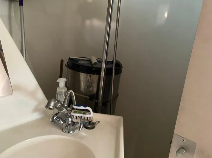 Foxy Yacht Photos Pics Bathroom sink area with cleaning supplies, Sundeer 56, 1995 model.