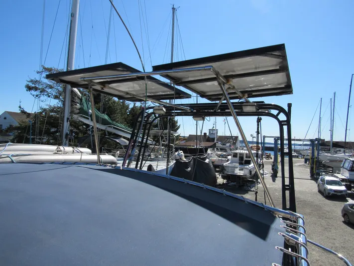 Foxy Yacht Photos Pics Sundeer 56 sailboat with solar panels, docked in a marina, clear blue sky.