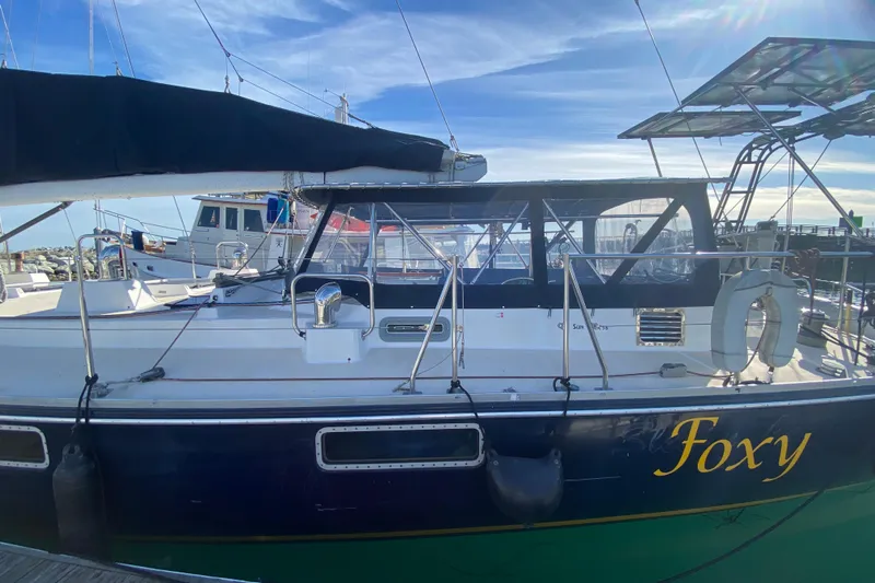 Foxy Yacht Photos Pics Sundeer 56 sailboat from 1995 named "Foxy" docked at a marina.