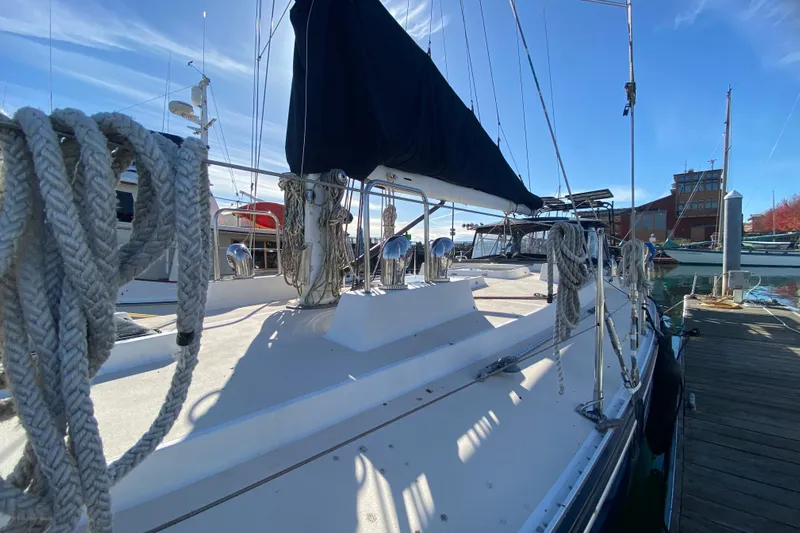 Foxy Yacht Photos Pics Sundeer 56 sailboat from 1995 docked at a marina, featuring ropes and sails.
