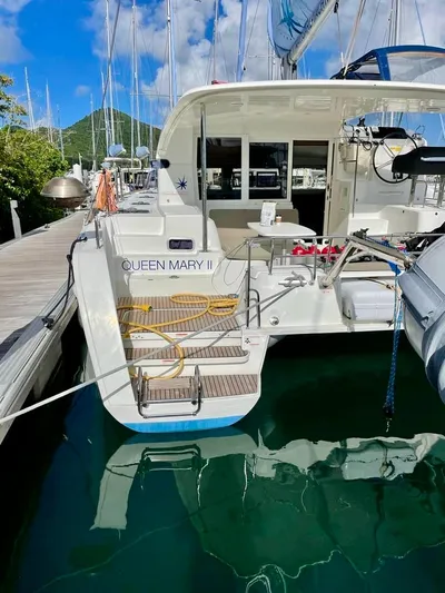 Queen Mary II Yacht Photos Pics 2019 Lagoon 40 catamaran docked, rear view with "Queen Mary II" name visible.