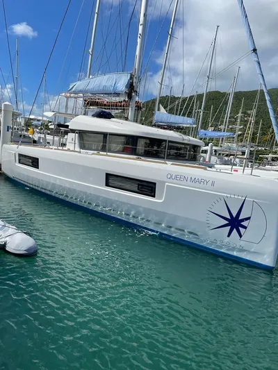 Queen Mary II Yacht Photos Pics 2019 Lagoon 40 catamaran docked in a marina with clear blue water.