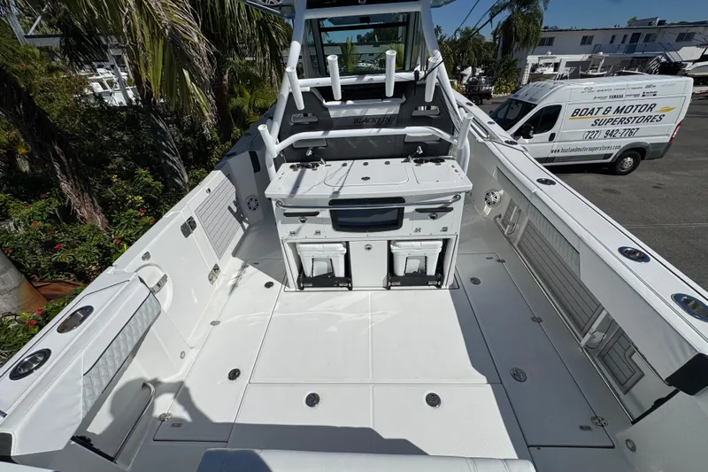  Yacht Photos Pics 2021 Blackfin 332 CC boat interior with fishing setup and storage compartments.