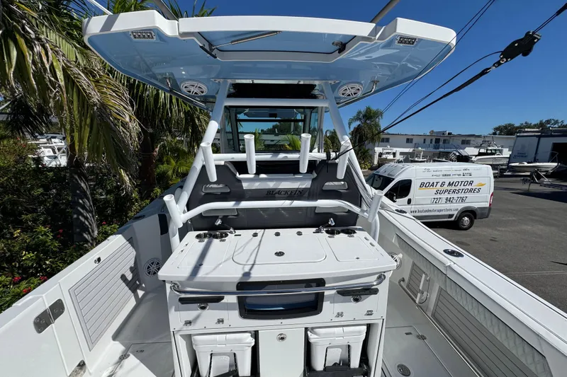  Yacht Photos Pics 2021 Blackfin 332 CC boat with T-top and fishing setup in a dealership lot.