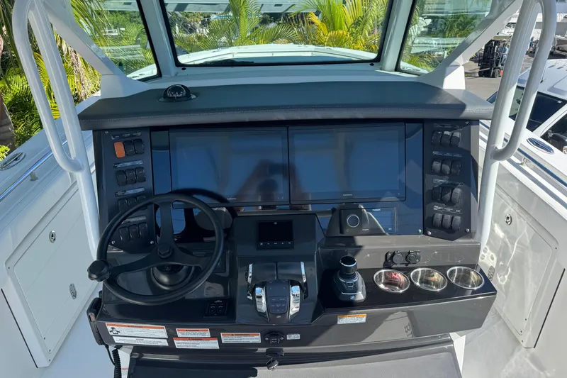  Yacht Photos Pics 2021 Blackfin 332 CC helm with dual screens, steering wheel, and control panel.