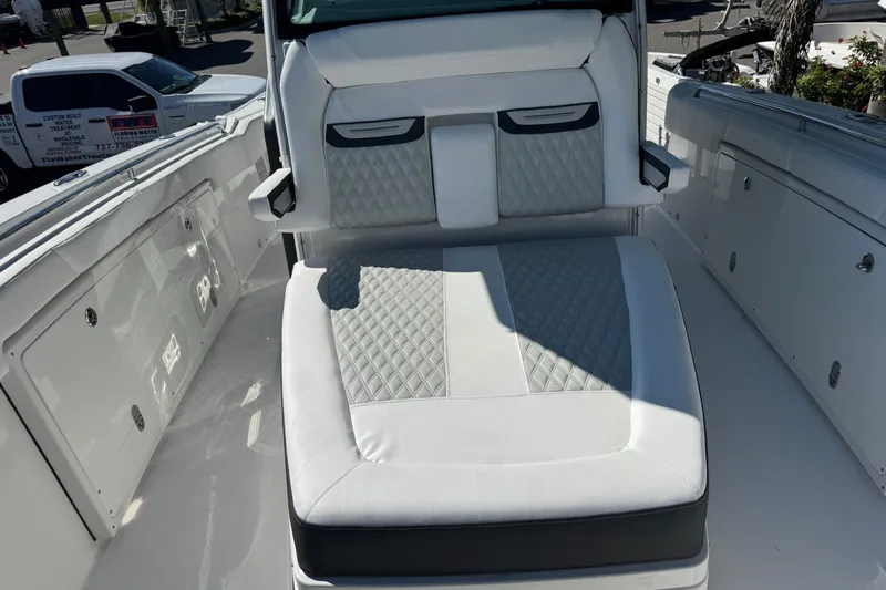  Yacht Photos Pics 2021 Blackfin 332 CC boat interior with cushioned seating and storage compartments.