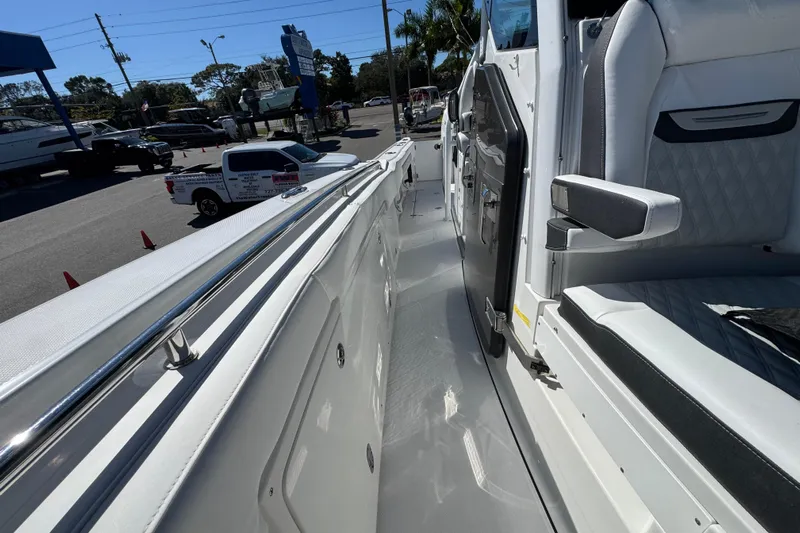  Yacht Photos Pics 2021 Blackfin 332 CC boat interior with seating, docked at a marina.