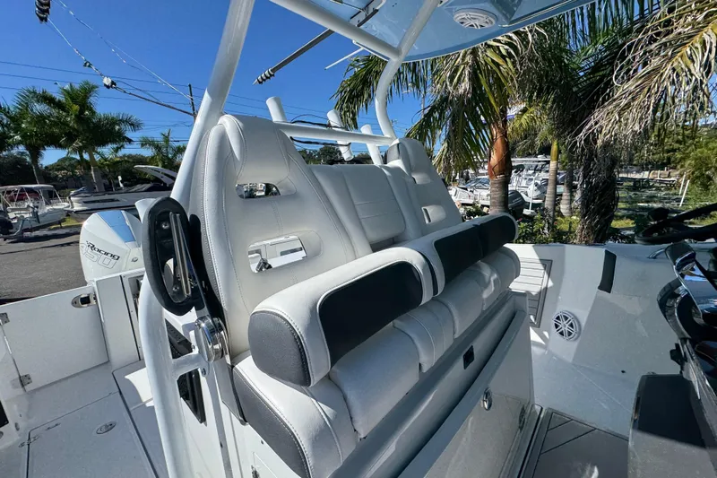  Yacht Photos Pics 2021 Blackfin 332 CC boat interior with luxurious seating and palm trees in the background.