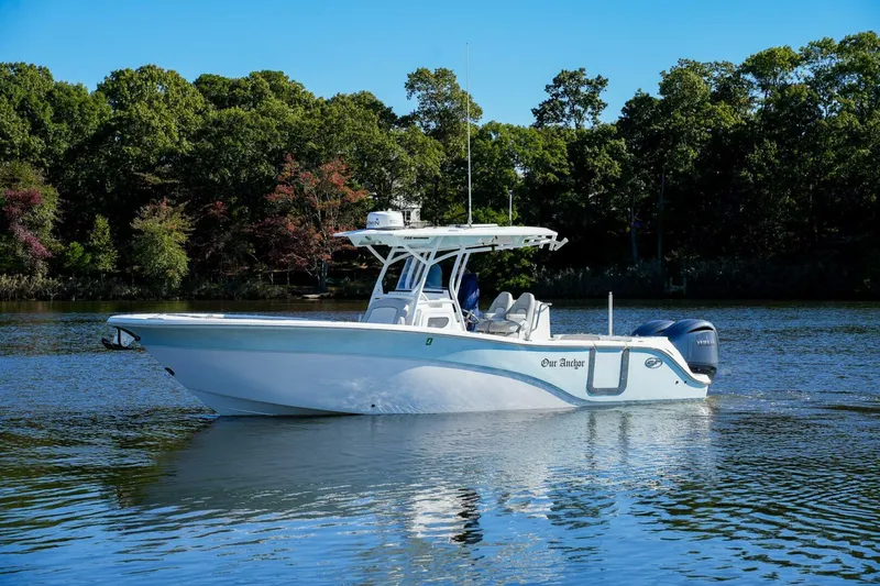  Yacht Photos Pics 2022 Sea Fox 288 Commander boat on calm water, surrounded by lush trees.