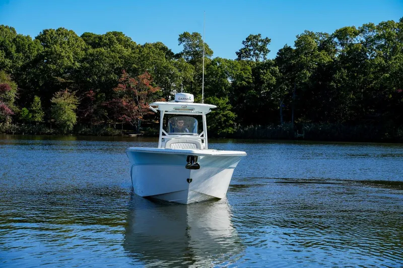  Yacht Photos Pics 2022 Sea Fox 288 Commander boat cruising on a serene lake with lush green trees.