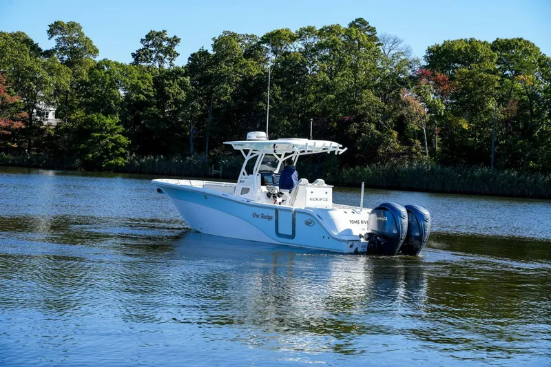  Yacht Photos Pics 2022 Sea Fox 288 Commander boat cruising on a calm river with lush green trees.