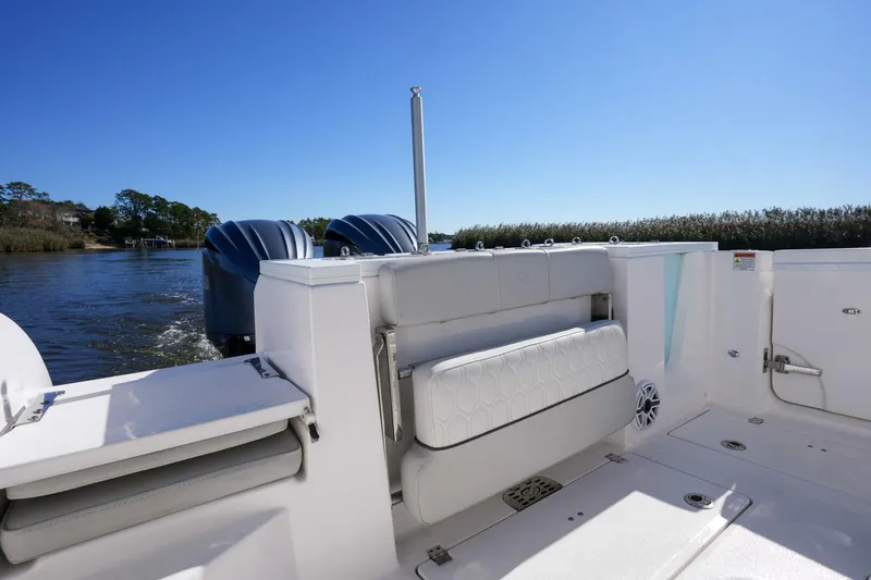  Yacht Photos Pics 2022 Sea Fox 288 Commander boat interior with dual engines and seating, on a sunny day.