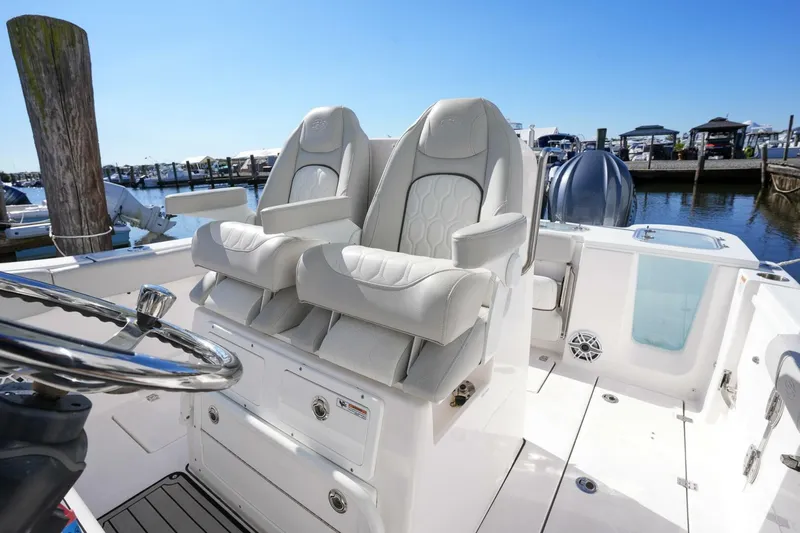 Yacht Photos Pics 2022 Sea Fox 288 Commander boat interior with dual captain's chairs at marina.