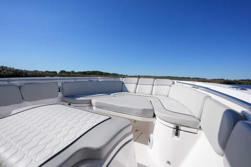  Yacht Photos Pics 2022 Sea Fox 288 Commander boat interior with cushioned seating under clear blue sky.