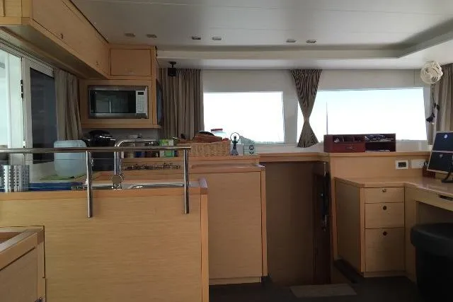 Whatif Yacht Photos Pics Interior of a 2013 Lagoon 450 catamaran with modern kitchen and ample natural light.