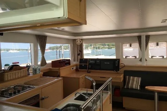 Whatif Yacht Photos Pics Interior of 2013 Lagoon 450 catamaran with modern kitchen and scenic window views.