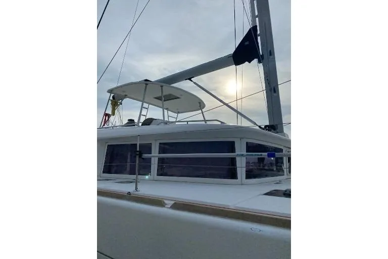 Whatif Yacht Photos Pics 2013 Lagoon 450 catamaran with sails, under a cloudy sky.