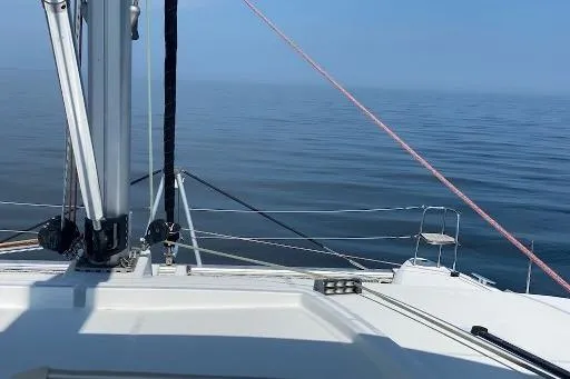 Whatif Yacht Photos Pics Lagoon 450 catamaran sailing on calm sea, clear blue sky, 2013 model.