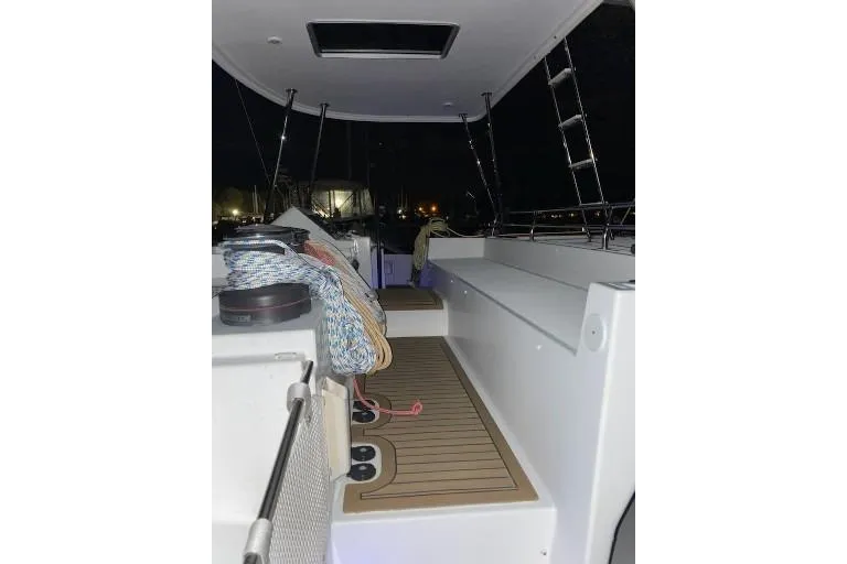 Whatif Yacht Photos Pics 2013 Lagoon 450 yacht deck at night, featuring ropes and seating area.