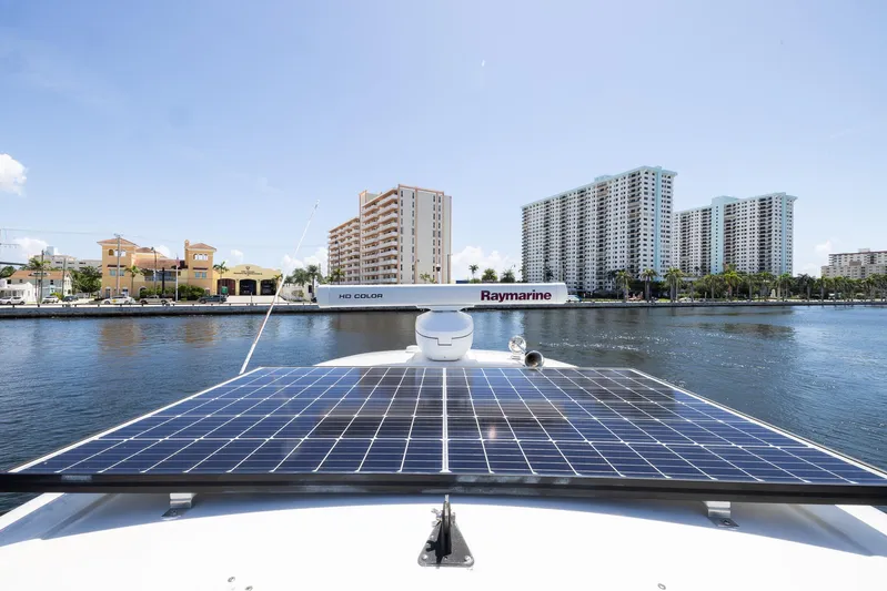 Pura Vida Yacht Photos Pics Sea Ray 370 Sundancer 2012 with solar panels, city skyline in background.