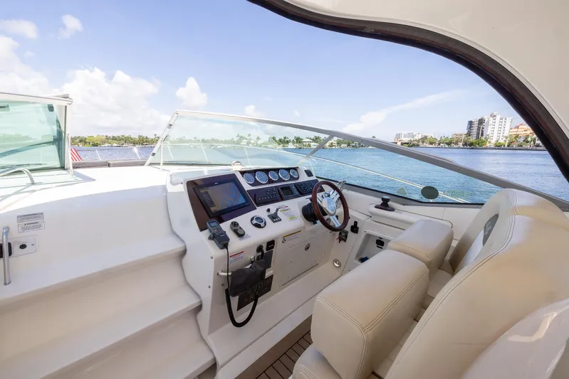 Pura Vida Yacht Photos Pics Interior helm of 2012 Sea Ray 370 Sundancer yacht with scenic water view.