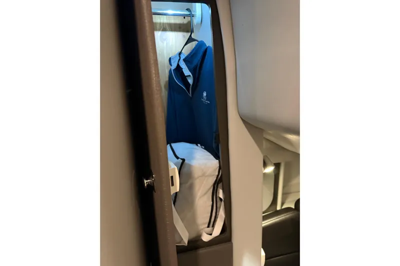  Yacht Photos Pics 2018 Formula 400 Super Sport cabin closet with blue jacket and white bag.