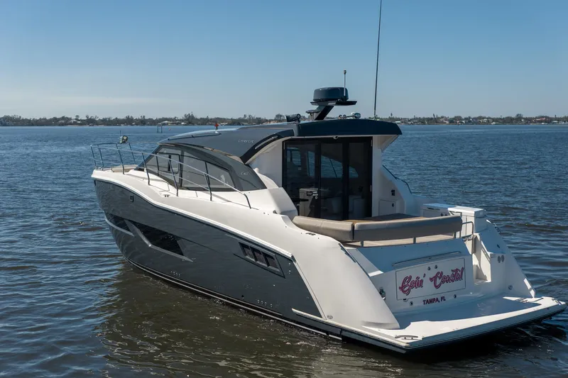 Going Coastal Yacht Photos Pics 2019 Carver C43 Coupe yacht on calm water, rear view.