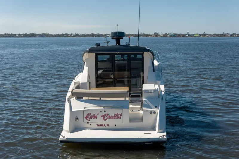 Going Coastal Yacht Photos Pics 2019 Carver C43 Coupe yacht on calm water, rear view, Tampa, FL.
