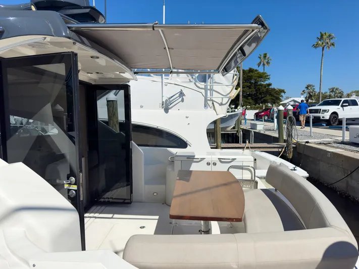 Going Coastal Yacht Photos Pics Luxury yacht deck with seating and table, featuring a Carver C43 Coupe, 2019 model.