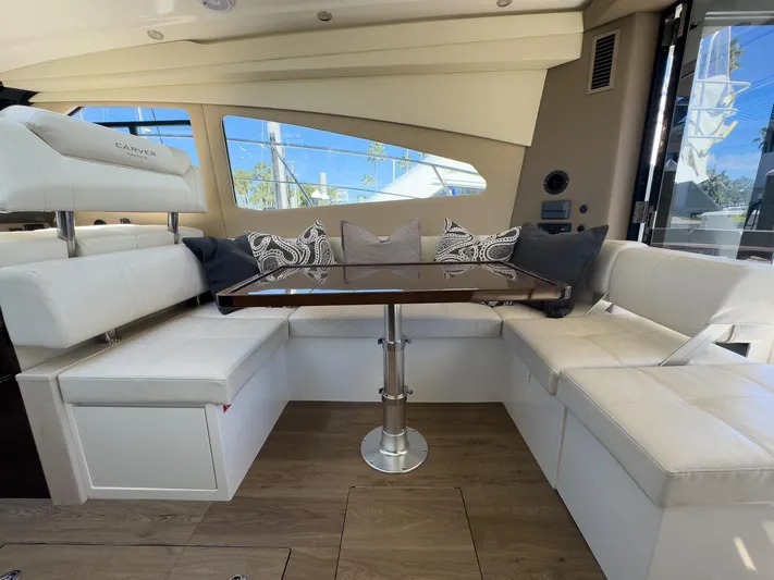 Going Coastal Yacht Photos Pics Luxurious interior of 2019 Carver C43 Coupe with elegant seating and table.