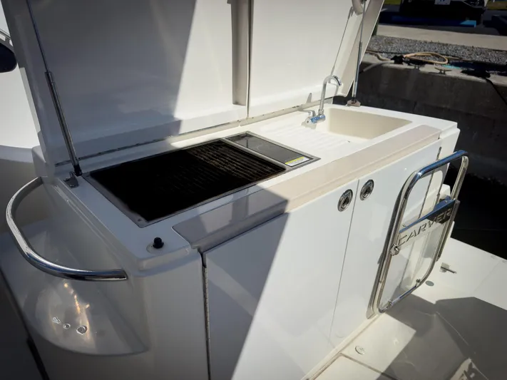 Going Coastal Yacht Photos Pics Outdoor kitchen on a 2019 Carver C43 Coupe yacht with grill and sink.