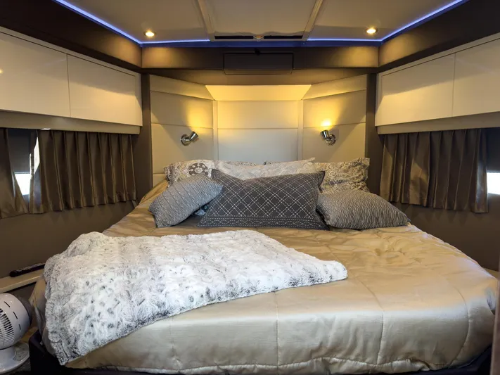 Going Coastal Yacht Photos Pics Luxurious bedroom interior of 2019 Carver C43 Coupe with elegant bedding and ambient lighting.