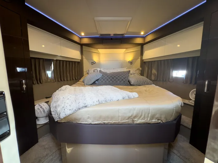 Going Coastal Yacht Photos Pics Luxurious bedroom interior in a 2019 Carver C43 Coupe yacht, featuring elegant bedding and ambient lighting.