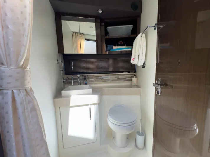 Going Coastal Yacht Photos Pics Modern bathroom interior in a 2019 Carver C43 Coupe yacht, featuring a sink and toilet.