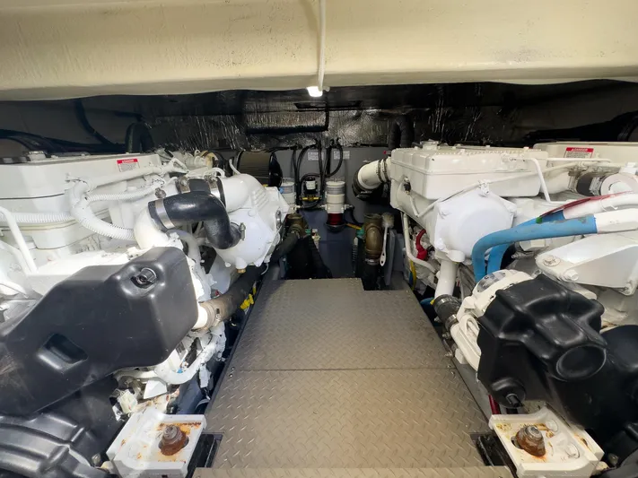 Going Coastal Yacht Photos Pics Engine room of a 2019 Carver C43 Coupe, featuring dual engines and mechanical components.