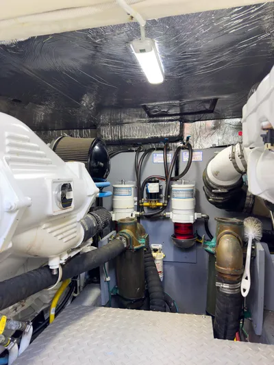 Going Coastal Yacht Photos Pics Engine room of a 2019 Carver C43 Coupe, showcasing mechanical components and piping.